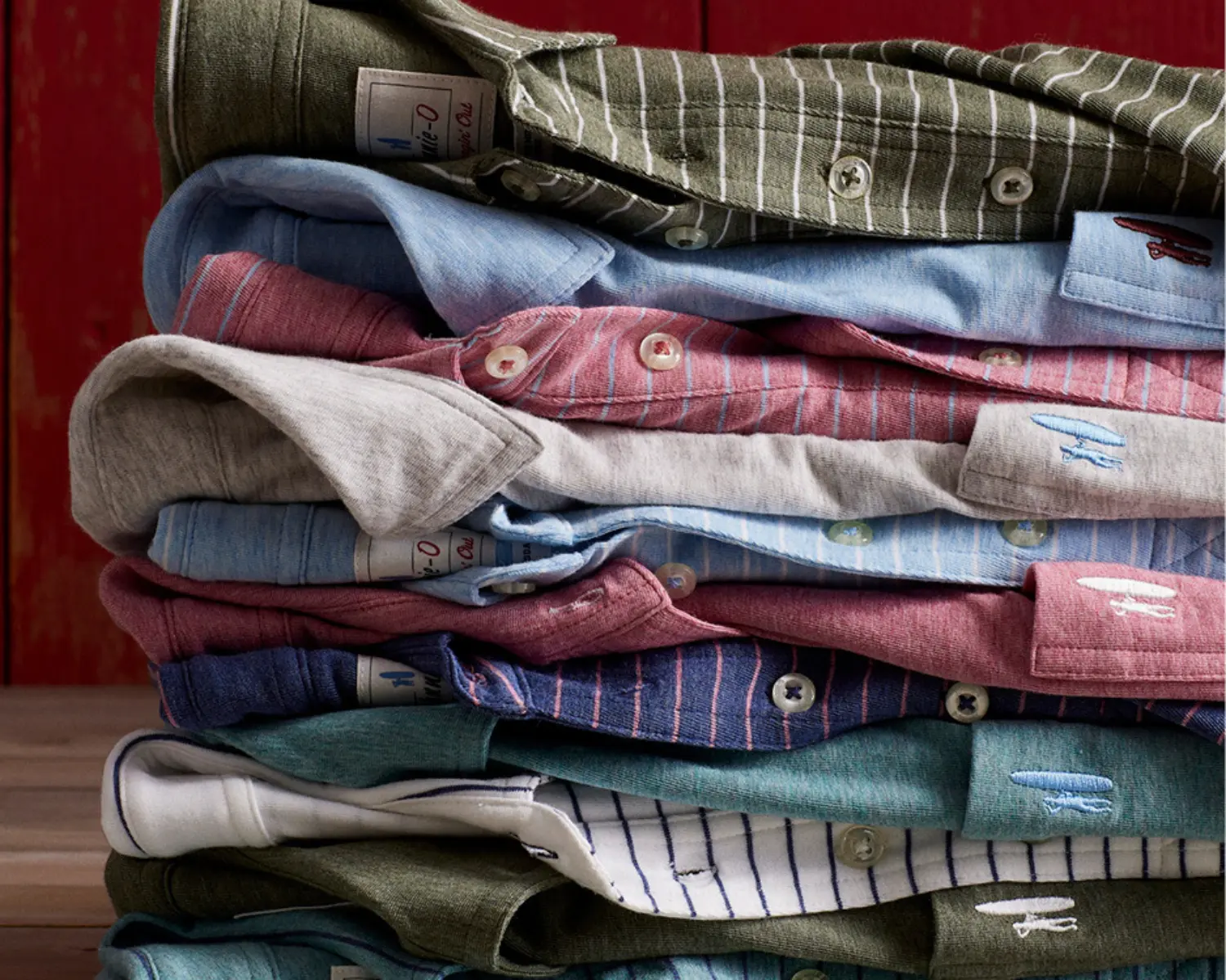 A stack of cotton polos in solid, stripe, and heather
