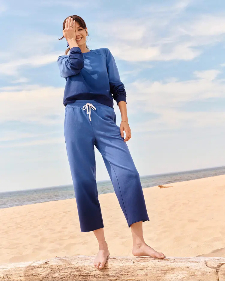 Woman dressed in a matching sweat set on the beach